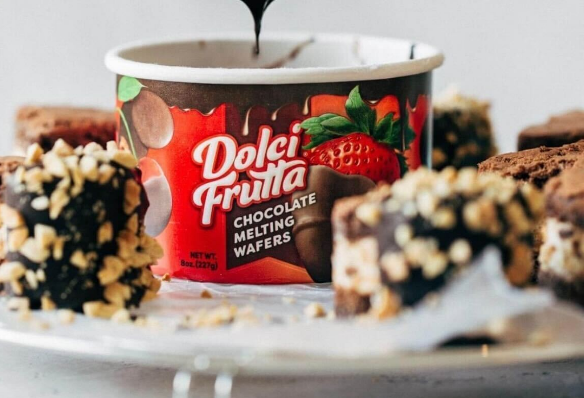 close up of Dolci Frutta Chocolate Meting Wafers surrounded by dipped heart-shaped ice cream cakes blurry in the background and foreground